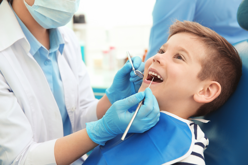 Dentist,Examining,Little,Boy's,Teeth,In,Clinic