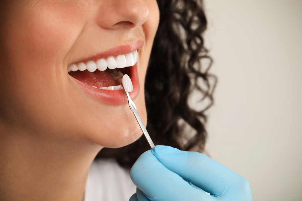 Doctor,Checking,Young,Woman's,Teeth,Color,On,Light,Grey,Background,